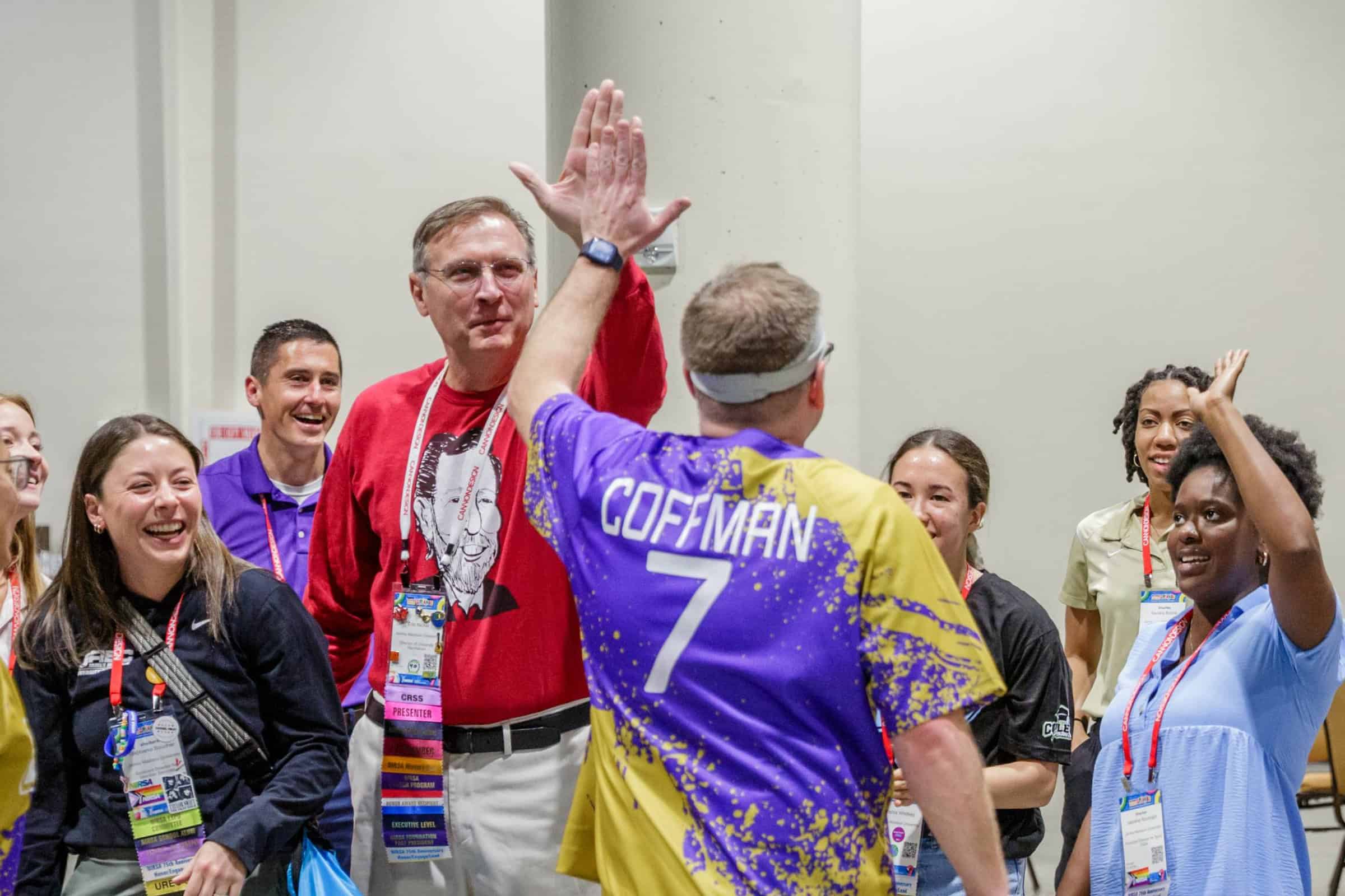 Pickleball player high fiving a conference attendee