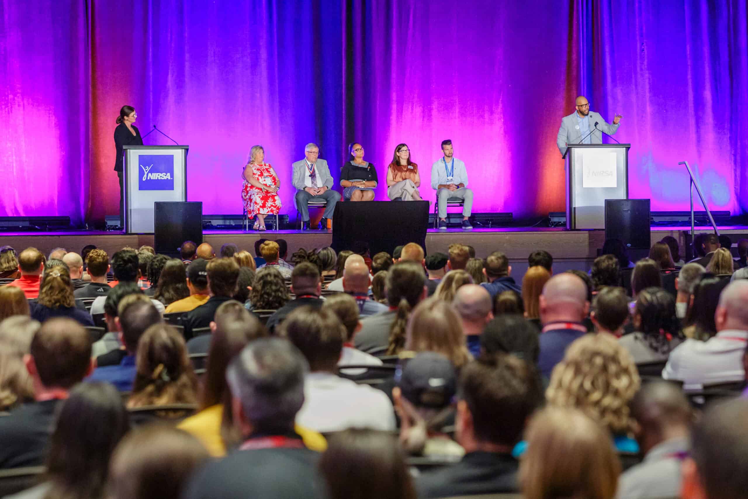 Panel speakers in front of the crowd at a NIRSA event