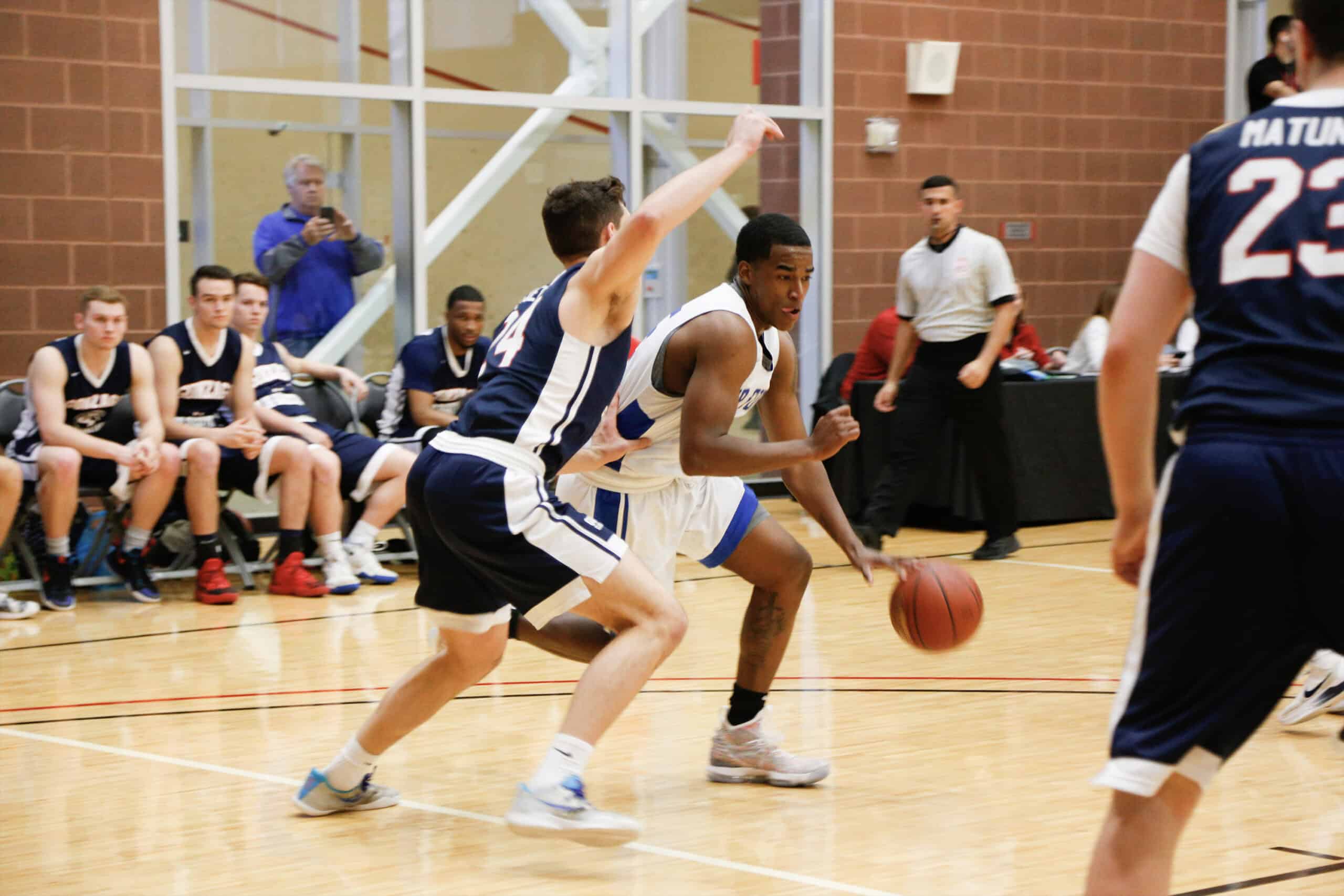 Two people playing on a basketball court