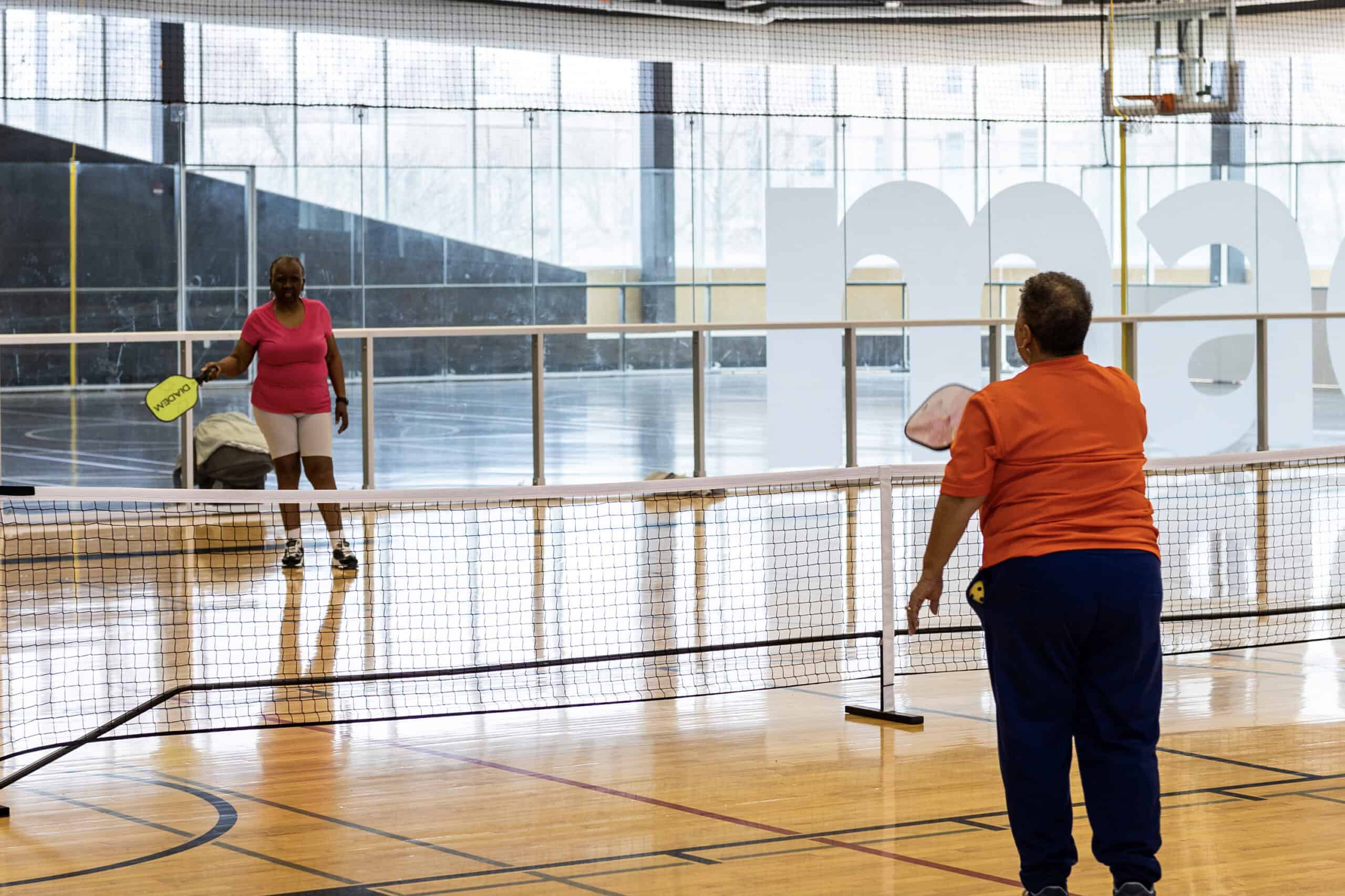 Two people playing pickelball