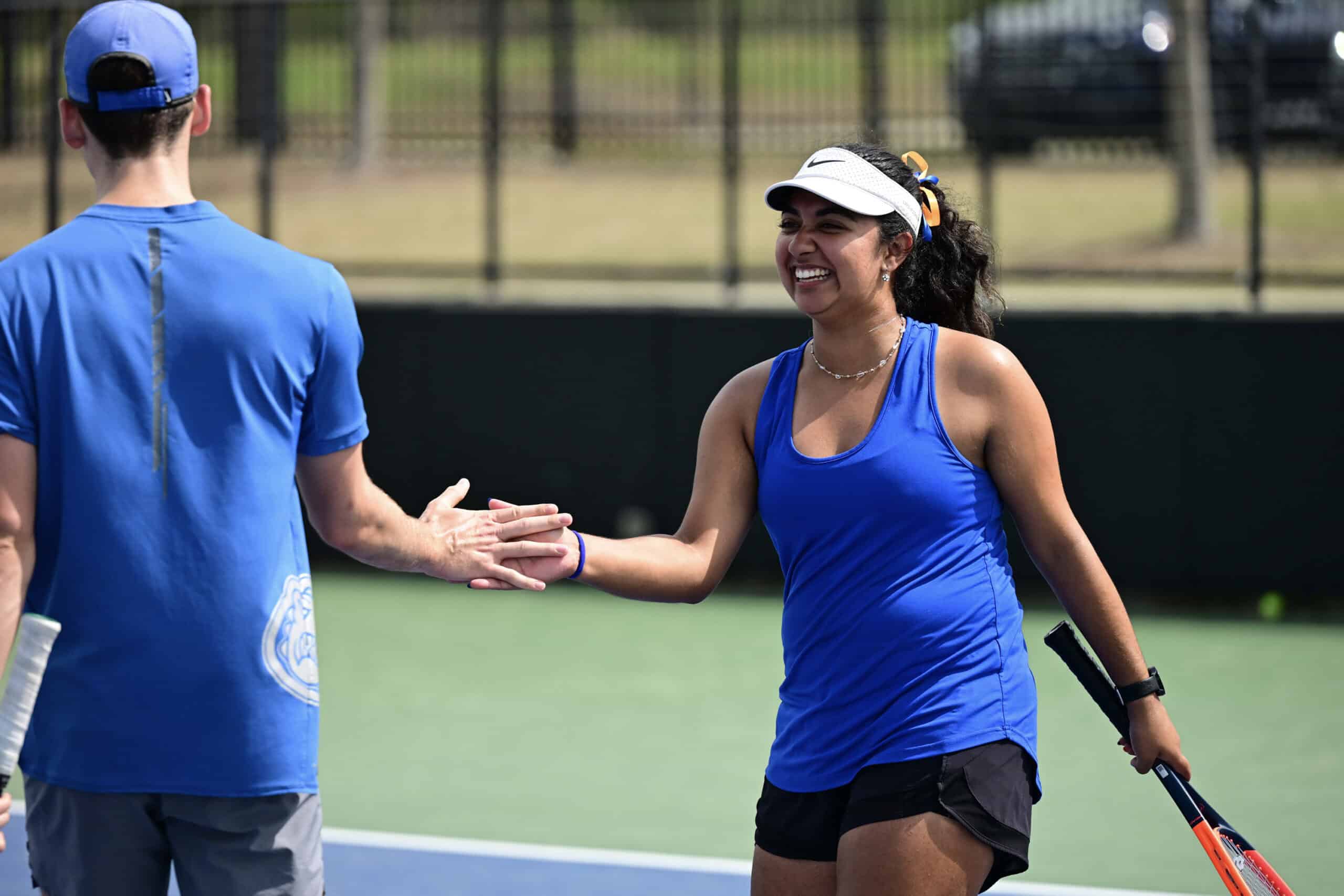 Two people celebrating after a tennis match