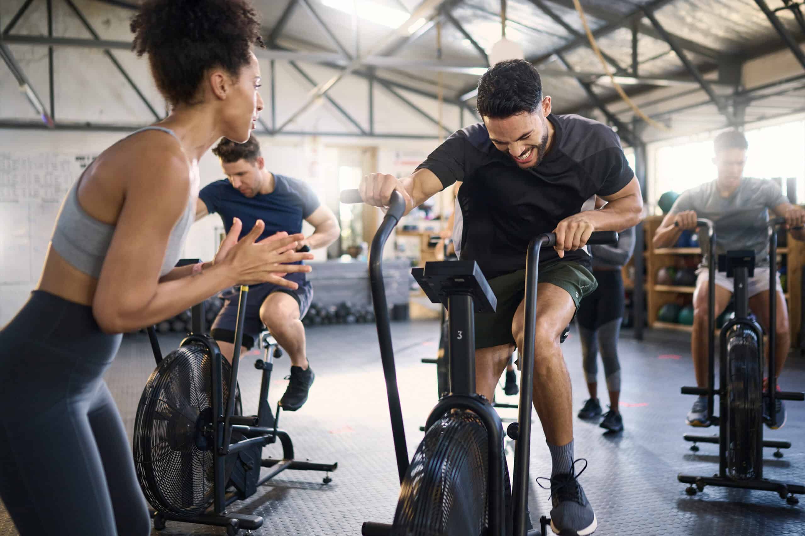 Person working out hard on a bike at a gym