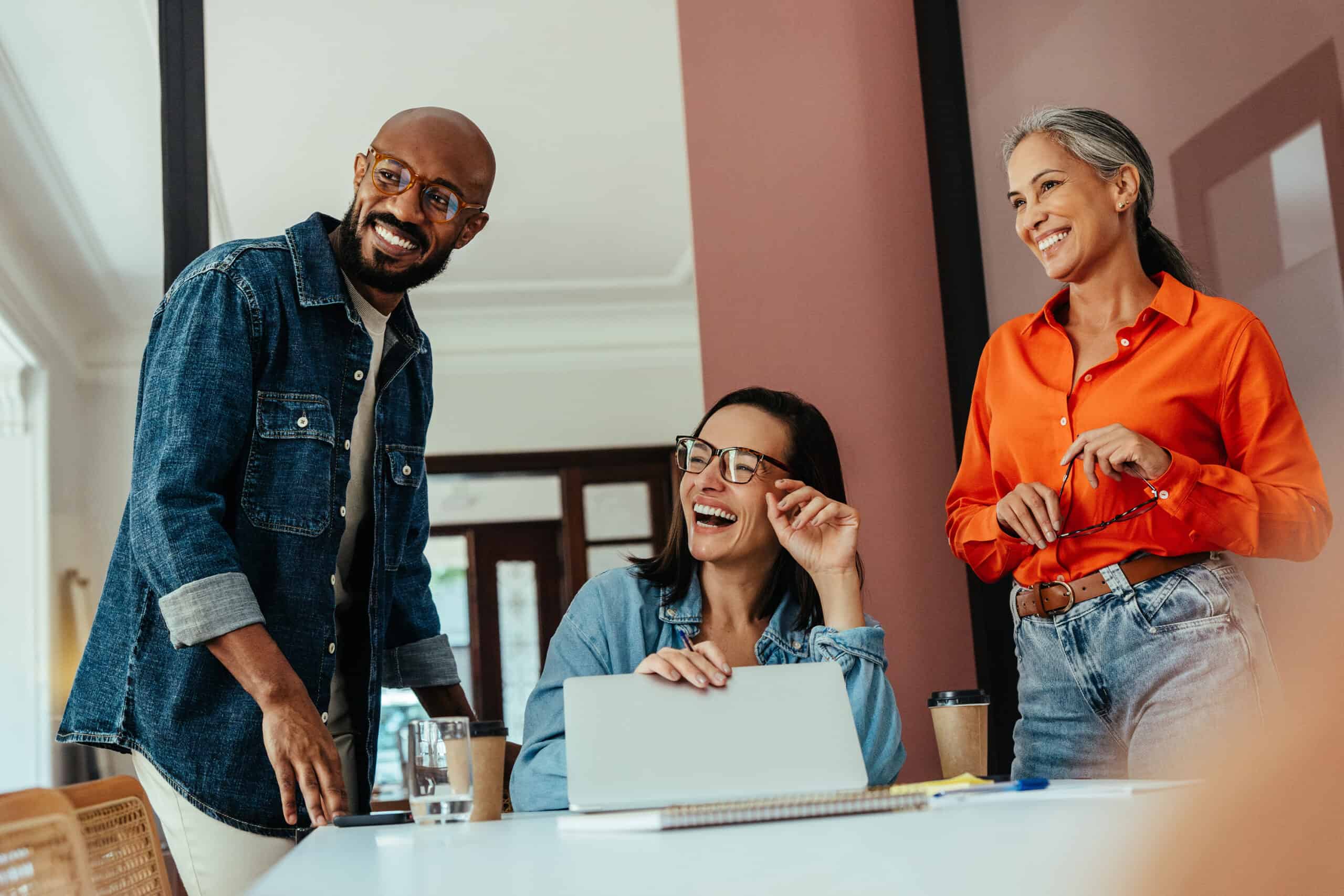 Group of people laughing and working together