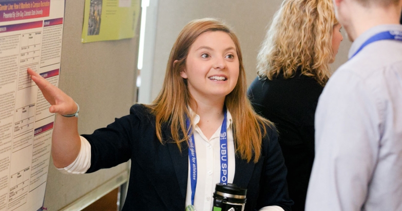 A poster presenter discusses her research