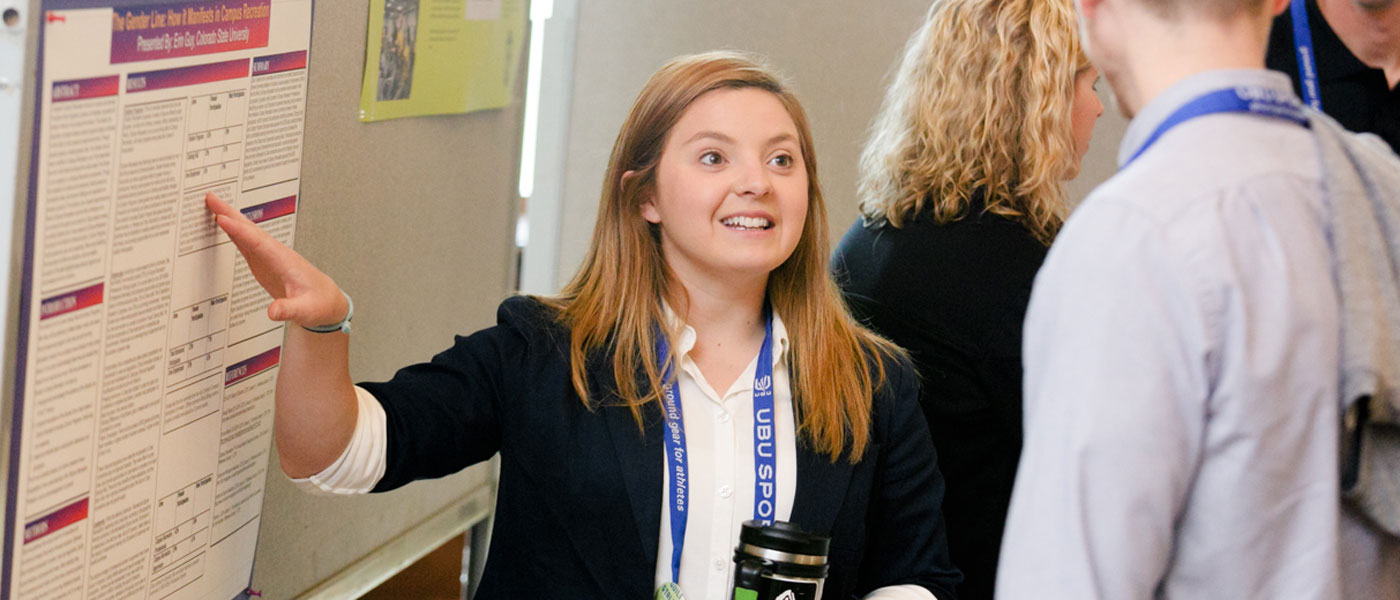 A poster presenter discusses her research